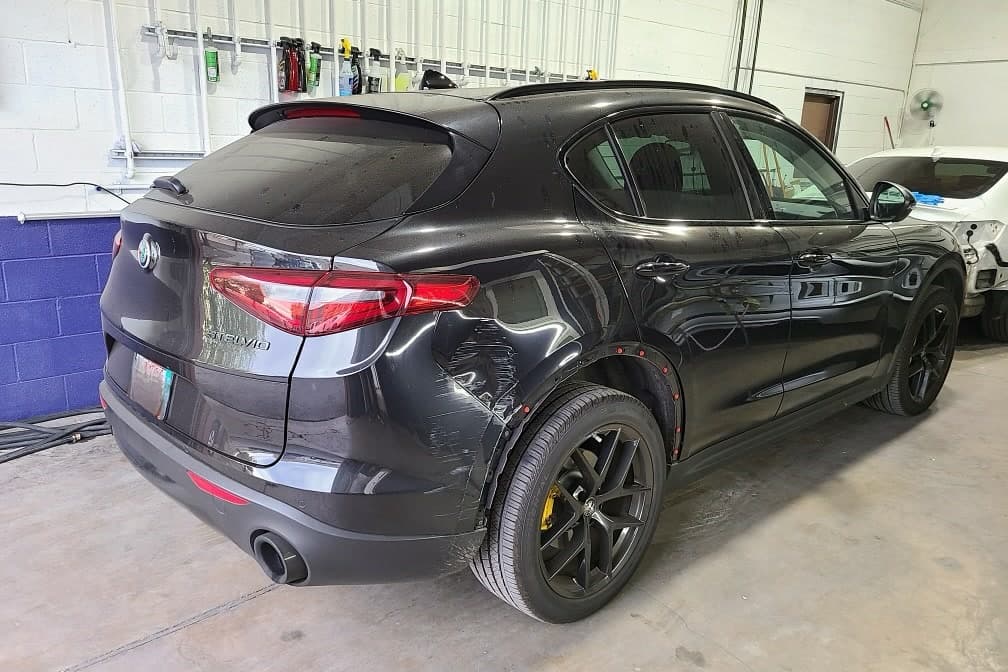 A black Alfa Romeo Stelvio in the shop's bay